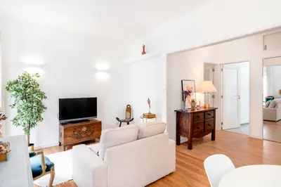 a living room with a white couch and a tv at ViVA Bright & Spacious Gaia in Vila Nova de Gaia