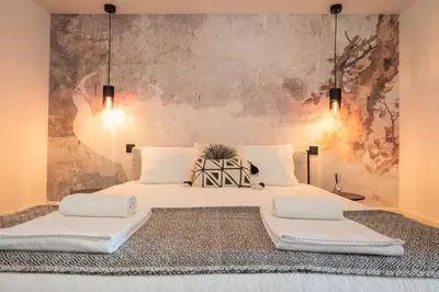 a bedroom with two beds with white pillows at Classy Garden in Porto