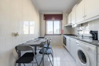 a kitchen with a table and chairs in it at GuestReady - Porto Panoramic View in Vila Nova de Gaia