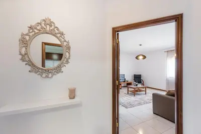 a mirror on a wall next to a living room at GuestReady - Porto Panoramic View in Vila Nova de Gaia