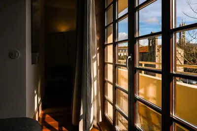 an open door with a view of a balcony at Casa Priorado - Charming View City Center in Porto