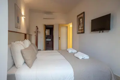 a bedroom with a large white bed with two pillows at Casa Priorado - Charming View City Center in Porto