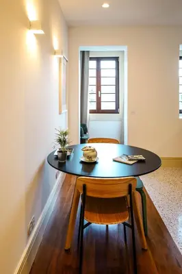 a dining room table with two chairs and a table at Casa Priorado - Charming View City Center in Porto