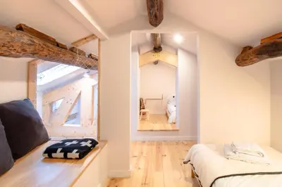 a bedroom with a bed and a mirror in a room at Olive Tree House by LovelyStay in Porto