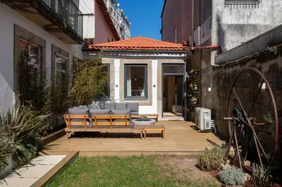 a patio with a couch in the middle of a building at Olive Tree House by LovelyStay in Porto