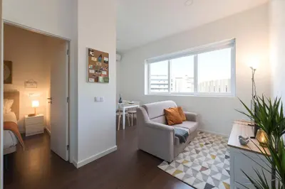 a living room with a chair and a window at Apartment Boavista Roundabout by Sweet Porto in Porto
