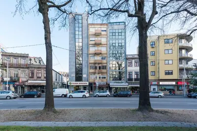 a city street with cars parked in front of buildings at Apartment Boavista Roundabout by Sweet Porto in Porto