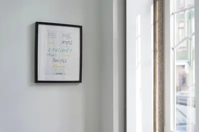 a picture frame hanging on a wall next to a window at Apartment Boavista Roundabout by Sweet Porto in Porto