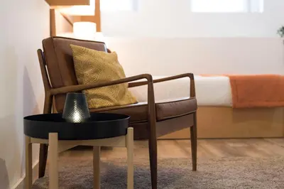 a chair and a table in a room with a bed at Apartment Boavista Roundabout by Sweet Porto in Porto