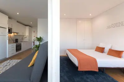 a bedroom with a bed and a couch in a room at Apartment Boavista Roundabout by Sweet Porto in Porto
