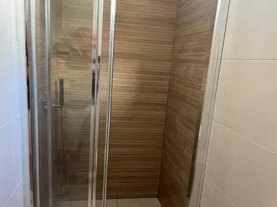 a shower with a glass door in a bathroom at River Pace III in Porto