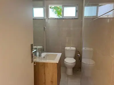 a bathroom with a toilet and a sink and a shower at River Pace III in Porto