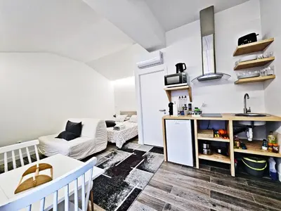 a small kitchen and living room with a couch at Ninho Studio in Vila Nova de Gaia