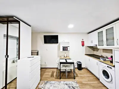 a kitchen with a table and a dining room at Ninho Studio in Vila Nova de Gaia