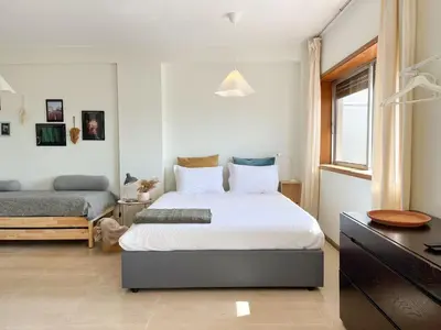a living room with a couch and a table at Casa Guilhermina, Sunny Studio with Balcony in Porto