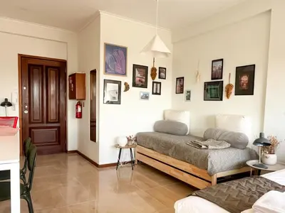a bedroom with two beds and pictures on the wall at Casa Guilhermina, Sunny Studio with Balcony in Porto