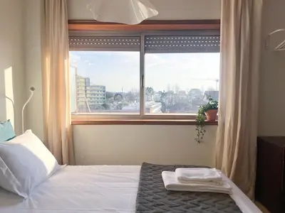 a bedroom with a bed and a dresser and a desk at Casa Guilhermina, Sunny Studio with Balcony in Porto