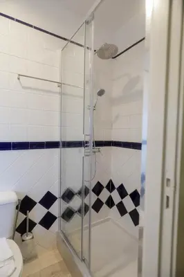 a glass shower in a bathroom with a toilet at Cedofeita Downtown Nightlife by PCH in Porto