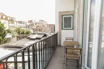 a balcony with two chairs and a table at Cedofeita Downtown Nightlife by PCH in Porto