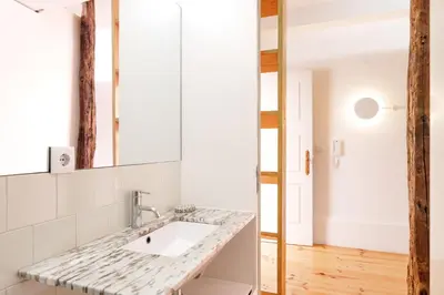 a bathroom with a sink and a mirror at VIVA Boho Chic in Porto