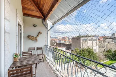 a balcony with two benches and a view of a city at VIVA Boho Chic in Porto
