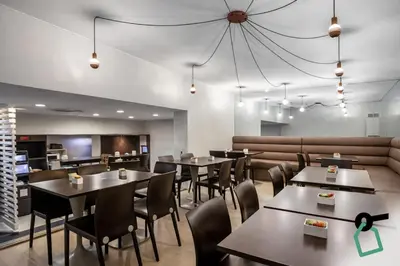 a restaurant with tables and chairs and a couch at HOTIDAY Room Collection - Oporto in Porto