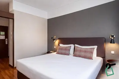 a bedroom with a large white bed with two pillows at HOTIDAY Room Collection - Oporto in Porto