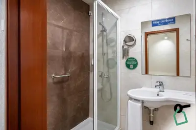 a bathroom with a shower and a sink at HOTIDAY Room Collection - Oporto in Porto