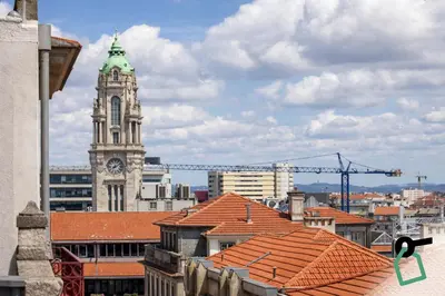a building with a clock tower in a city at HOTIDAY Room Collection - Oporto in Porto