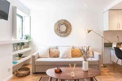 a living room with a couch and a table at FLH Porto Central TownHouse in Porto