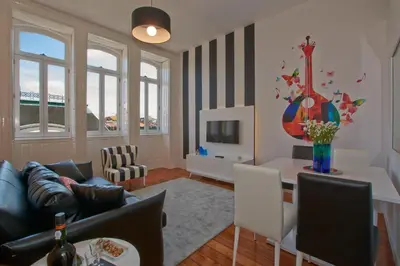 a living room with a couch and a table at Bolhão Nobre Apartments in Porto