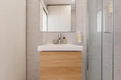 a bathroom with a sink and a shower at Cozee Bonjardim in Porto