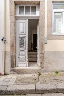 an open door of a building with a door at Cozee Bonjardim in Porto
