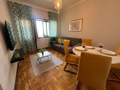a living room with a table and a couch at Happy Mountain in Porto