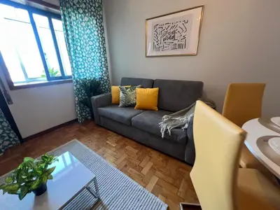 a living room with a couch and a table at Happy Mountain in Porto