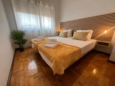 a bedroom with a large bed with a wooden headboard at Happy Mountain in Porto