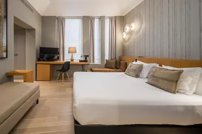 a hotel room with a large bed and a desk at Descobertas Boutique Hotel by Aspasios in Porto