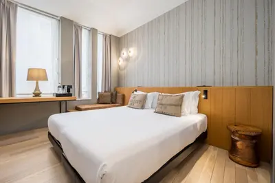 a bedroom with a large white bed and a window at Descobertas Boutique Hotel by Aspasios in Porto