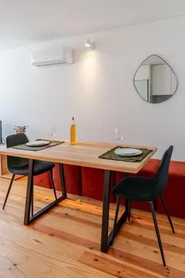 a dining room table with two chairs and a mirror at Topazio Apartment by Porto Stories in Porto