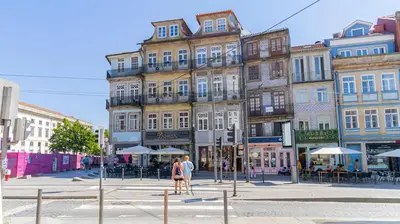 a building on a city street with people walking on the street at Carmo Apartamentos in Porto