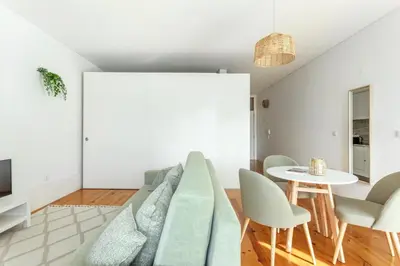 a living room with a couch and a table at Home M apartments in Porto