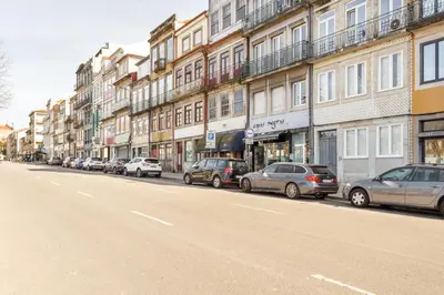 a row of cars parked on the side of a street at Home M apartments in Porto