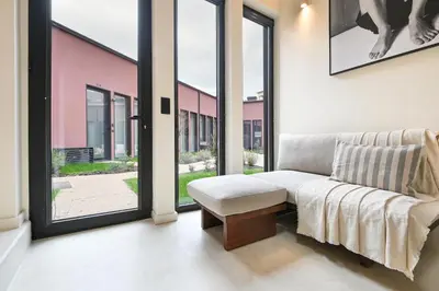 a living room with a couch and large windows at ON Apartments - Cozy - Free Parking & Pet Friendly in Porto