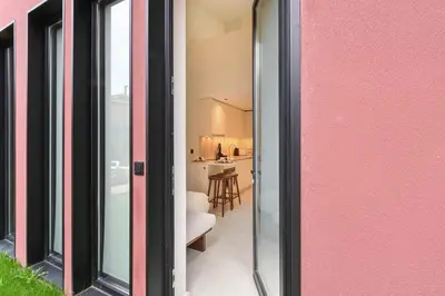 a view of a living room and kitchen through a sliding glass door at ON Apartments - Cozy - Free Parking & Pet Friendly in Porto