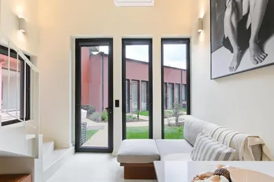 a living room with a couch and windows at ON Apartments - Cozy - Free Parking & Pet Friendly in Porto