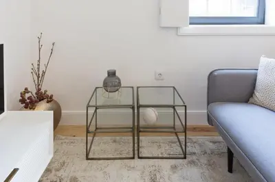 a living room with a glass table and a couch at OPorto Cosy and Modern Loft in Porto