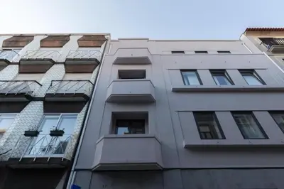 a tall white building with windows on the side of it at OPorto Cosy and Modern Loft in Porto