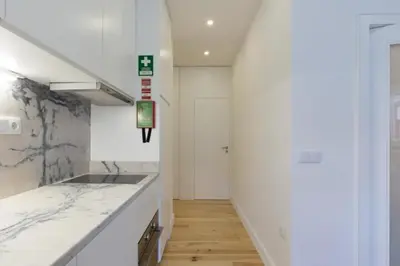 a kitchen with white walls and a counter top at OPorto Cosy and Modern Loft in Porto