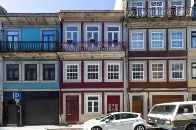 two cars parked in front of a building at Alegria Rubi - Urban Oasis with Garden in Porto