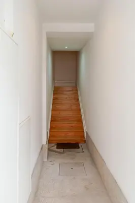 a hallway with white walls and a wooden floor at Visconde de Gandara Apartment by Porto Stories in Porto